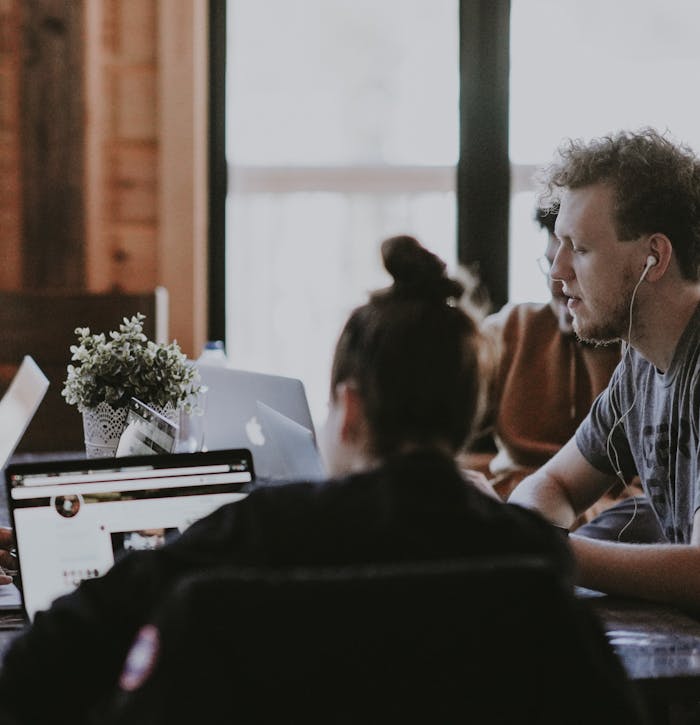 group of team members working in front of laptops together