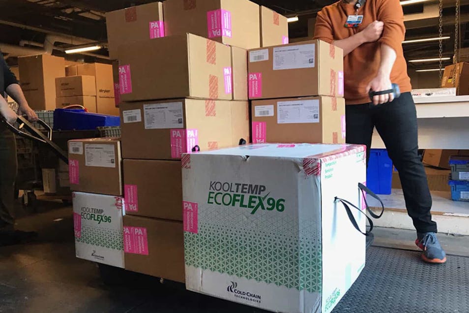 A CoxHealth employee moves boxes in a warehouse